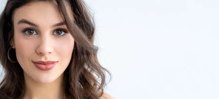 Beauty banner. Skin care. Rejuvenation wellness. Confident pretty woman with flawless smooth face skin plump lips looking at camera isolated on white empty space advertising background.の写真素材
