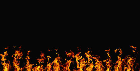 Burning banner. Flame design. Barbecue heat. Bright orange yellow hot fire glow with sparks isolated on black night abstract copy space background.の写真素材