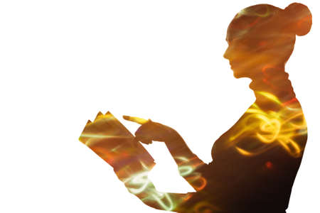 Double exposure silhouette. Knowledge power. Wisdom intelligence. Blur neon yellow red light curvy lines in dark contrast profile outline of woman reading book isolated on white empty space background.の写真素材