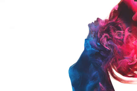 Double exposure silhouette. Spiritual aura. Esoteric enlightenment. Blue pink ethereal mist chakra in dark contrast profile outline of inspired woman body isolated on white copy space background.の写真素材