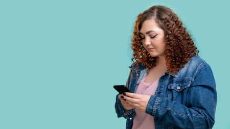 Mobile technology. Social network. Active lifestyle. Advertising background. Smiling plus size woman...