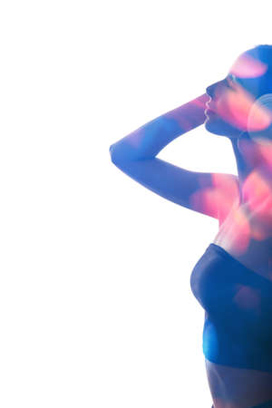 Double exposure silhouette. Disco party. Colorful neon blue pink bokeh light in profile shape portrait of woman enjoying listening music in headphones isolated on white copy space background.の写真素材