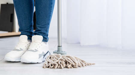 Cleaning service. Housework company. Home chores. Advertising background. Unrecognizable woman legs...