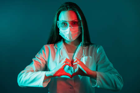 Pandemic support. Medical care. Coronavirus charity. Grateful female doctor in face mask goggles...