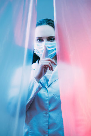 Medical secret. Health privacy. Confidential treatment. Female doctor in protective face mask...