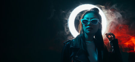 Cyberpunk people. Futuristic banner. Urban fashion. Blue neon light Asian girl in glasses with...