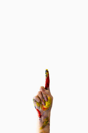 Art school. Design project. Creativity inspiration. Advertising background. Female hand with colorful paint splashes pointing finger up isolated white copy space.の写真素材