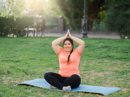 Body acceptance. Stress relief. Health well-being. Satisfied cheerful smiling overweight obese woman...