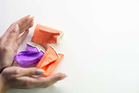 Human responsibility. Global warming. Save planet. Respecting nature. Woman hands around used crushed plastic trash isolated on white copy space background.の写真素材