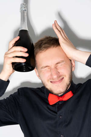 Celebration hangover. Party headache. Alcohol intoxication. Unwell birthday guy suffering from pain...