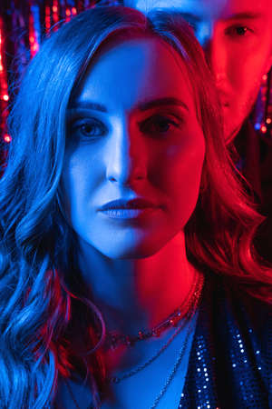 Neon light couple. Festive portrait. Disco night. Anniversary party. Confident glamour woman man...