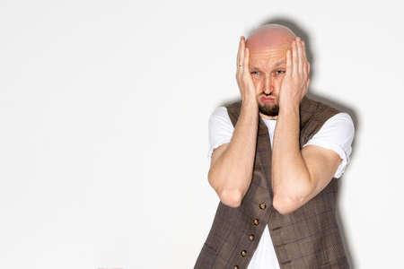 All lost. Desperate man. Depressed emotion. Project fail. Unfortunate situation. Hopeless guy feeling frustration grasping head by hands isolated white copy space.の写真素材