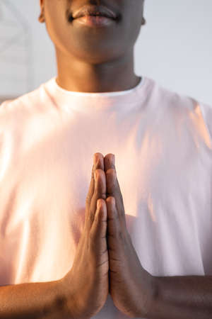 Meditation insight. Inspired black man. Home yoga. Peaceful mind. Unrecognizable african guy...