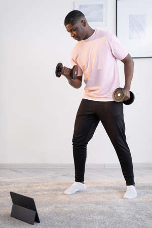 Home sport. Muscular black man. Online gym. Body building. Healthy lifestyle. Concentrated african...