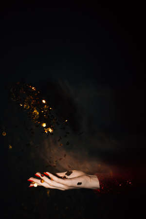 Christmas spirit. Festive background. Holiday decor. Female hands holding together opened palm...