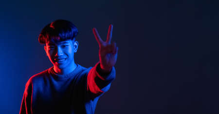 victory sign neon light banner man hand peaceの写真素材