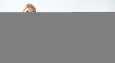 Fitness equipment. Sportive woman. Presenting product. Advertising background. Happy fit lady showing rubber bend in hands for workout isolated white copy space.の写真素材