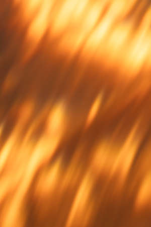 Blur light background. Bokeh glow. Fall sun shine design. Lens flare. Defocused golden orange black gleam abstract texture overlay.の写真素材