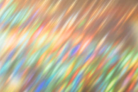 Lens flare overlay. Rainbow glow. Festive illumination. Magic glare. Defocused holographic neon orange green blue bokeh light abstract background.の写真素材