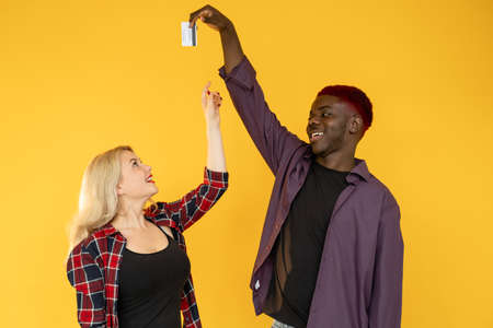 Couple finances. Family income. Shopping together. Happy multiracial millennials African man teasing...