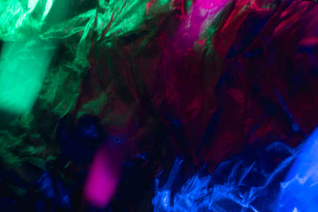 Blur color background. Creased texture. Distressed material. Defocused neon light magenta pink green...
