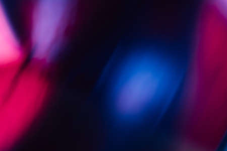 Blur glow overlay. Neon flash light. Ultraviolet radiance flare filter. Defocused uv led pink purple blue color flecks on dark black abstract background.の写真素材