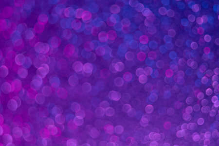 Bokeh glow. Fluorescent background. Blur firework sparks . Defocused neon purple blue color light...