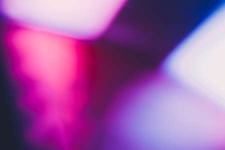 Color lens flare. Futuristic background. Blur fluorescent uv led illumination. Defocused neon magenta pink purple white light on dark abstract overlay.の写真素材