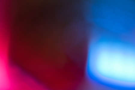 Blur color flare. Neon glow background. Bokeh radiance reflection. Defocused fluorescent pink blue light gleam on dark abstract overlay.の写真素材