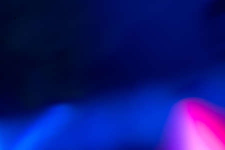 Lens flare overlay. Defocused glow. Bokeh ultraviolet light leak. Blur neon pink blue color glare texture on dark abstract background.の写真素材