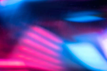 Futuristic background. Blur neon glow. Fluorescent illumination. Defocused ultraviolet pink blue color light abstract pattern dust scratches noise texture on dark overlay.の写真素材