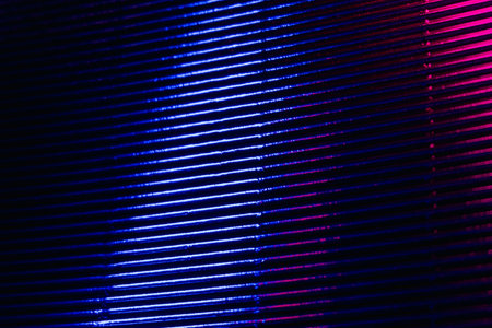 Neon grunge background. Ribbed texture. Glowing corrugated steel. Fluorescent blue magenta pink...