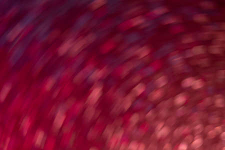 Bokeh light texture. Neon background. Glowing circles swirl. Festive illumination. Defocused fluorescent red orange blue round sparks on bright abstract overlay.の写真素材