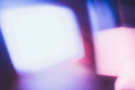 Defocused neon glow. Light flare overlay. Futuristic led illumination. Blur ultraviolet blue pink white color radiance on dark abstract background.の写真素材
