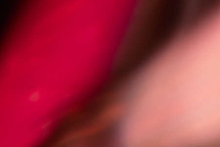 Blur glow overlay. Color light flare. Bokeh radiance reflection. Defocused neon magenta peach pink glare on abstract copy space background.の写真素材