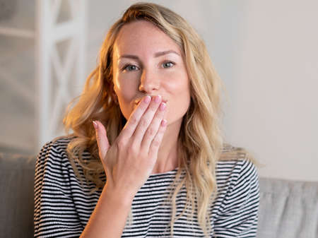 Blowing kiss. Pretty woman. Beloved expression. Smiling beautiful lady casual look sending love...
