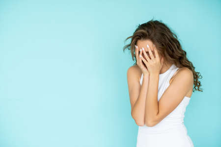 Shocked situation. Offended woman. Desperate feelings. Sad depressed lady covering face with hands...