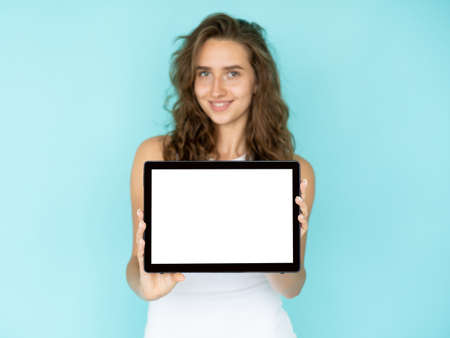 Digital news. Happy woman. Online technology. Pretty smiling lady showing tablet computer with blank...