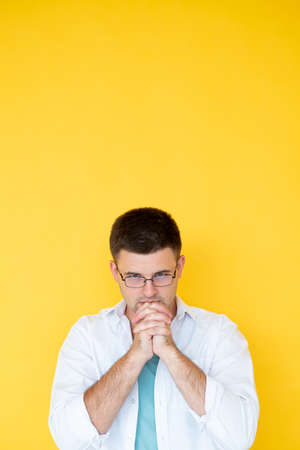 Hopeful planning. Serious man. Success believes. Handsome concentrated guy holding hands in...