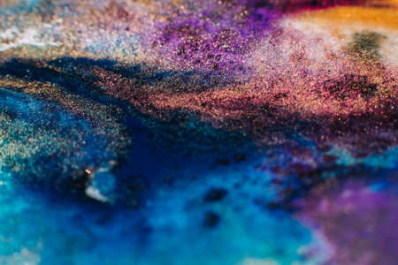 Liquid paint art. Macro ink background. Blue purple orange colors mixの写真素材