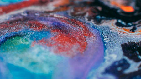 Ink blend. Artistic hobby. Colorful abstract bakgrund. Purple lavender pink blue glitter paints mixの写真素材