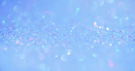 Bokeh light. Iridescent background. Underwater sequin reflection. Defocused pastel pink color shiny...