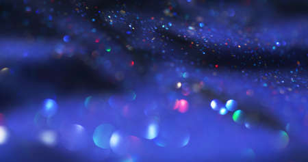 Bokeh light. Glitter bubbles. Lens flare overlay. Defocused neon colorful shimmering circles on dark blue grain texture abstract background.の写真素材