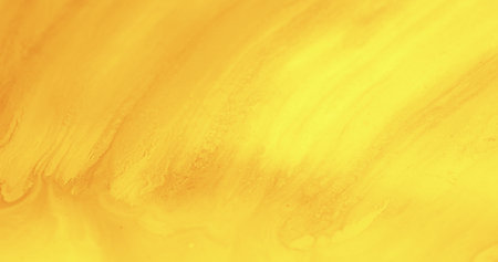 Yellow paint background. Ink stroke texture. Fluid spill. Solar radiance. Defocused orange color gradient dye leak abstract art banner.の写真素材