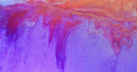 Glitter fluid. Wet ink texture. Shiny liquid mix. Defocused purple red orange color shimmering paint drip flow abstract art background.の写真素材