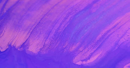 Ink water flow. Fluid spill. Glossy polish blend. Defocused fluorescent pink purple blue color wet dye leak mix abstract art background.の写真素材