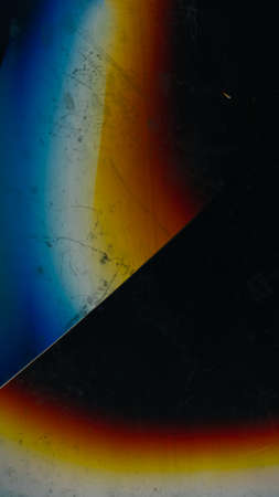 Screen glitch. Broken glass. Damaged texture. Fractured crystal. Cracked ice effect. Blue orange white distortion dust scratches dirt on dark black abstract overlay.の写真素材