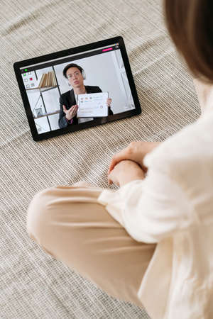 Video presentation. Web conference. Professional telecommuting. Relaxed female employee watching...