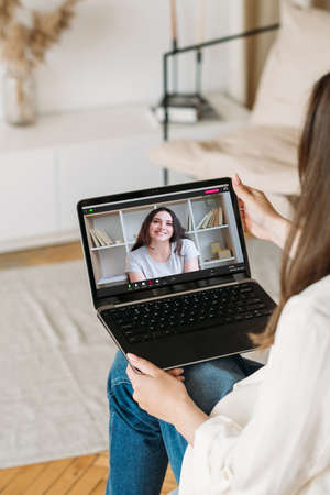 Home web chat. Virtual communication. Distance talk. Female friends meeting enjoying casual...