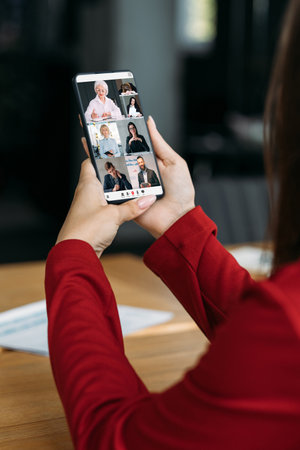 Video conference. Virtual meeting. Professional online consulting. Business colleagues discussing project working online in digital office on phone screen.の写真素材